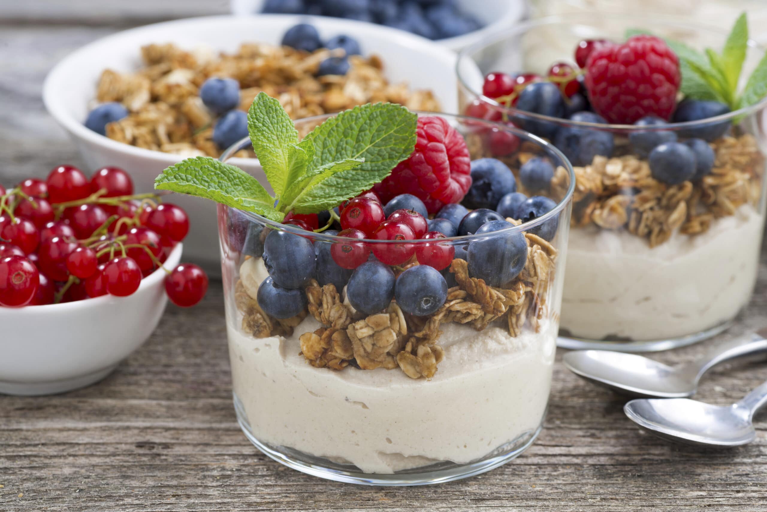 dessert with sweet cream, fresh berries and granola, closeup, horizontal