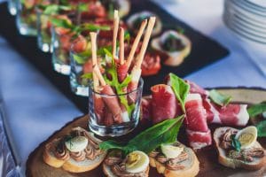 Beautifully decorated catering banquet table with different food snacks and appetizers on corporate christmas birthday party event or wedding celebration